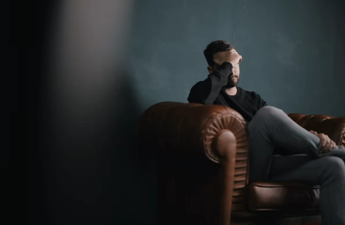 Person sitting quietly by a window, reflecting on feelings of depression