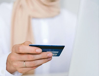 Person holding a payment card, representing insurance and private pay options for therapy