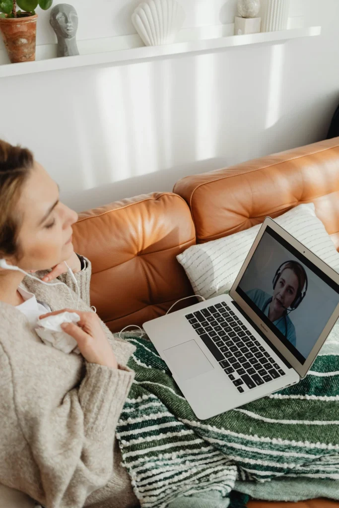 Person attending online therapy in California from home on a laptop
