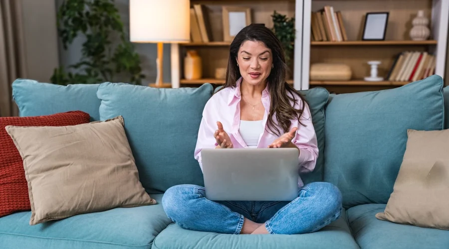 Woman attending online trauma therapy in California from home on a laptop